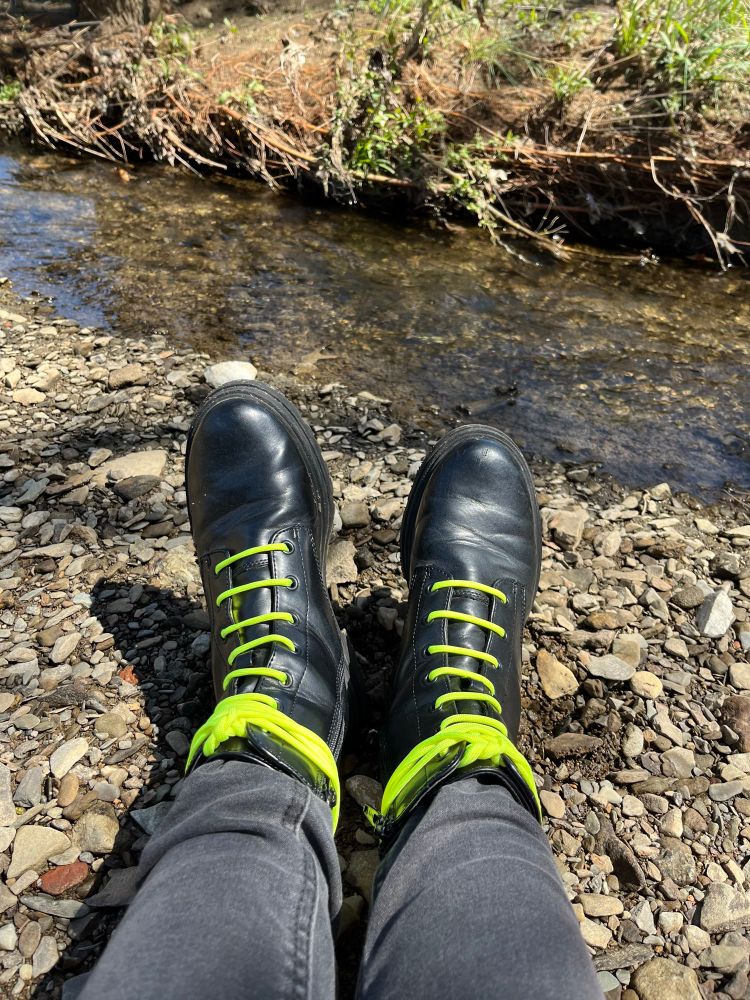 A photo of a small stream, and my boots coming up from the bottom of the frame.