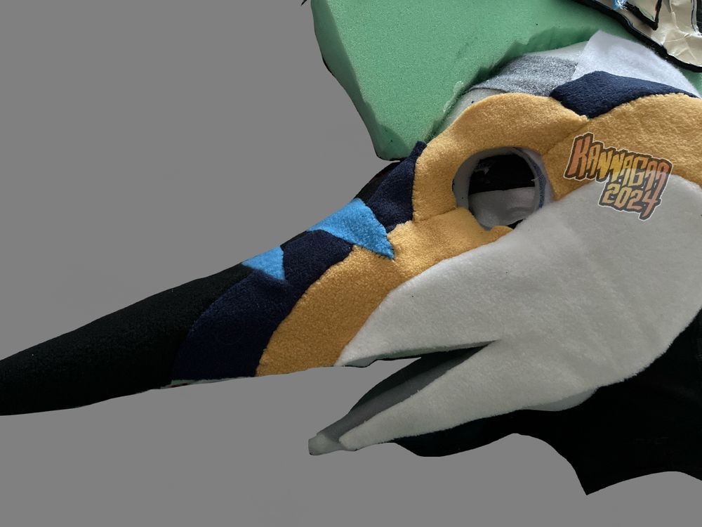 My blue marlin fursuit head base with the fleece skin partially laid over it to ensure it seems like it would fit mid-process 
