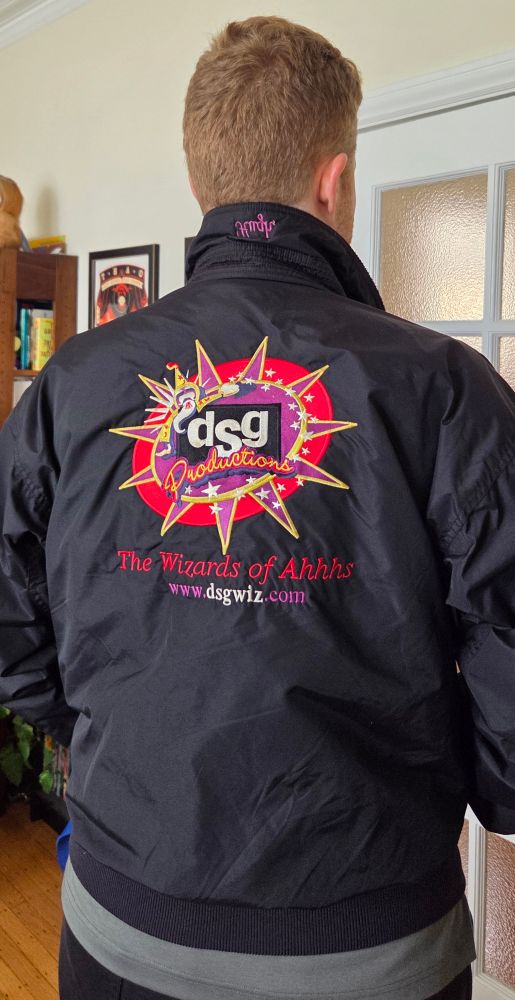 A bomber jacket from behind emblazoned with some kinda Vegas-y logo and stitched text that says The Wizard of Ahhhs