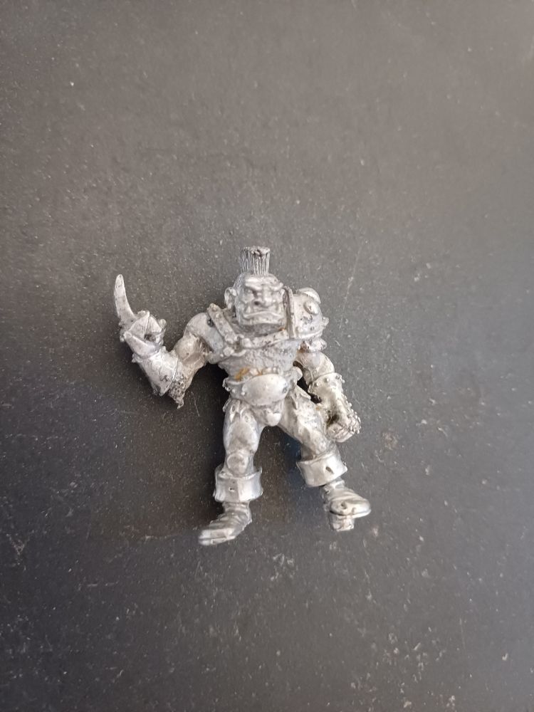 Bloodbowl 2nd wdition metal Ogre stripped of paint on a grey background