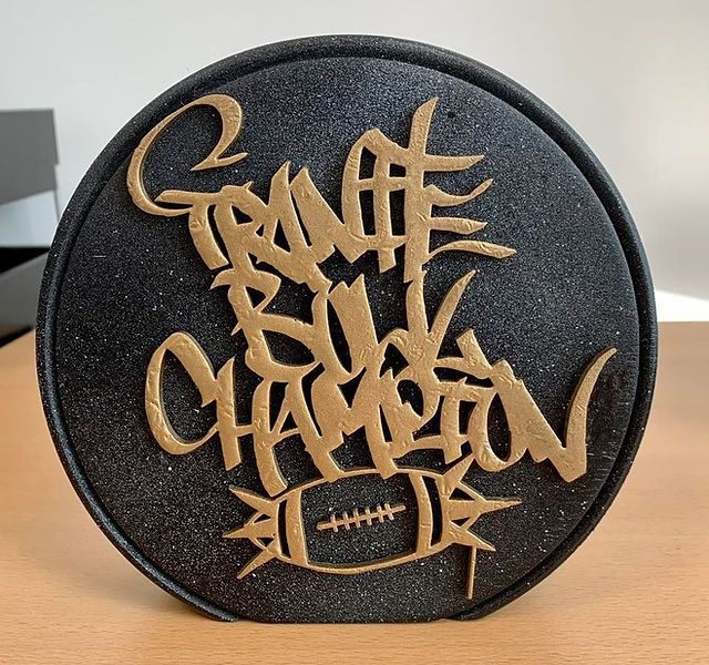 Granite Bowl champion trophy(?) Dark disk with gold writing which says: Granite Bowl Champion