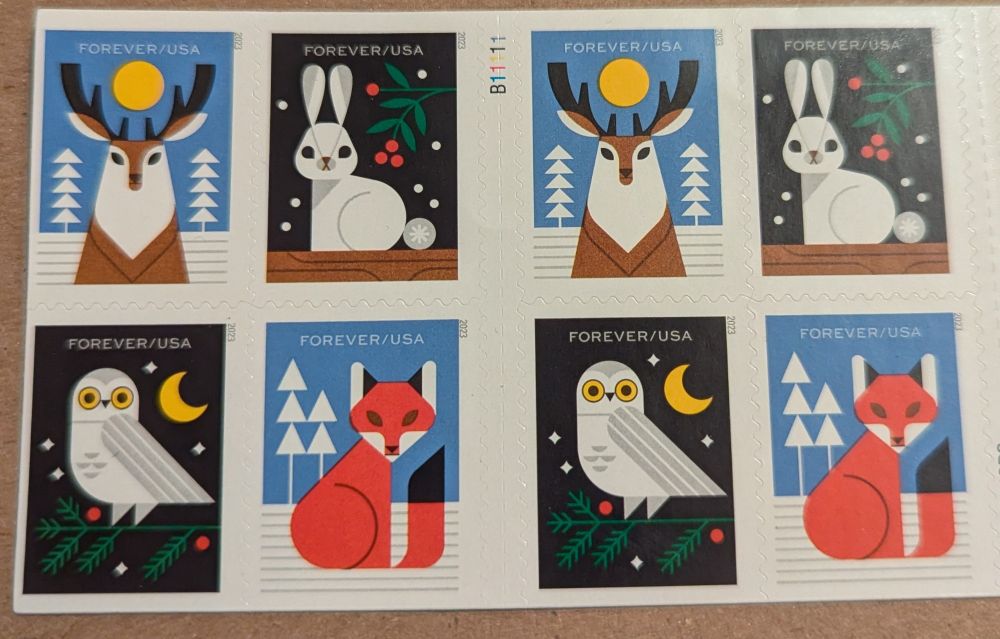 Two sets of four American forever stamps. All four stamps feature a critter looking at the viewer in a winter scene. One is a reindeer, one a white rabbit, one a fox, and one a snowy owl.