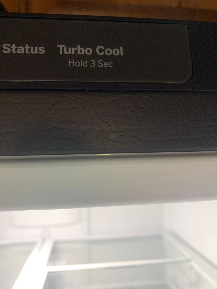Inside of a refrigerator. Text on the door says: “Status Turbo Cool (hold 3 sec)”