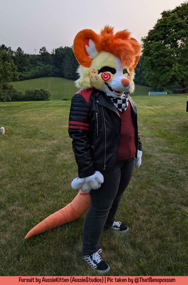 A male ginger, yellow and white mouse anthro furry standing while wearing charcoal coloured jeans with a black and red leather jacket and a red t-shirt with the aesthetic of cyberpunk. 