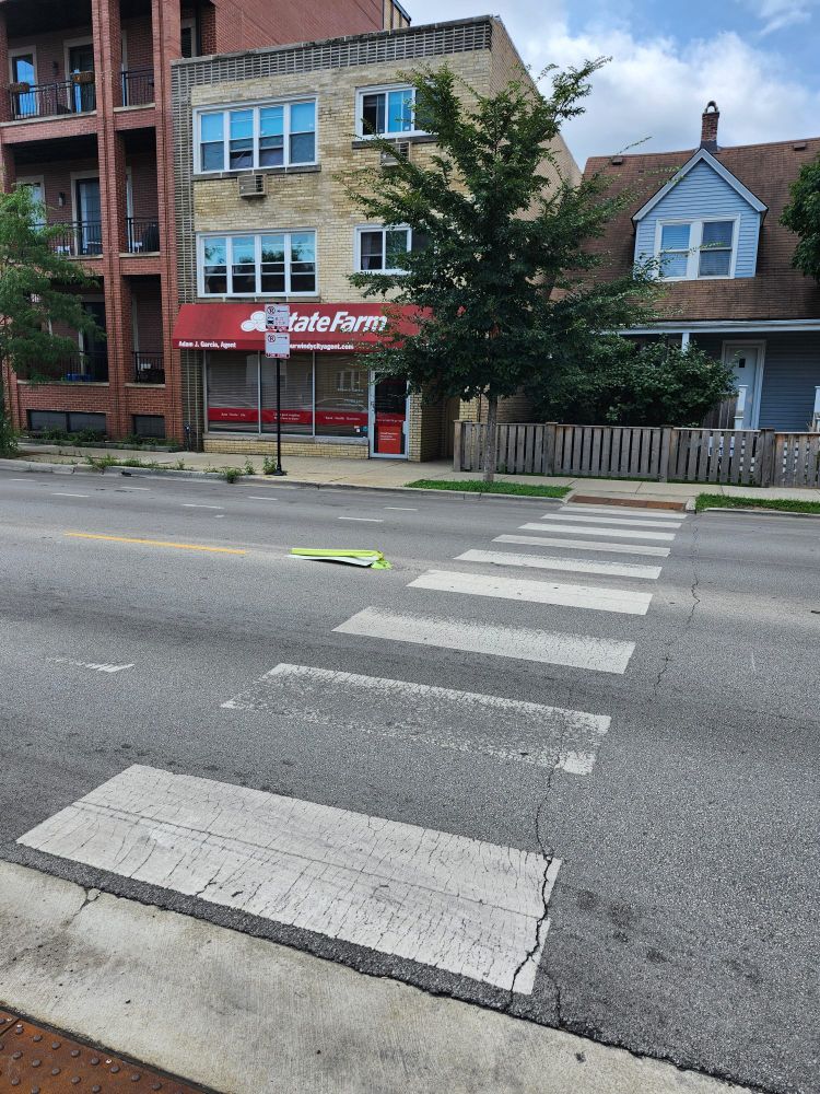 Pedestrian walking sign flattened at a cross walk