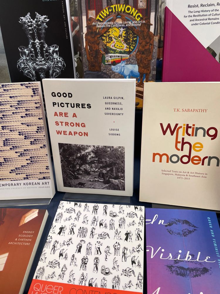 View of Good Pictures Are a Strong Weapon alongside other books on a display table. 
