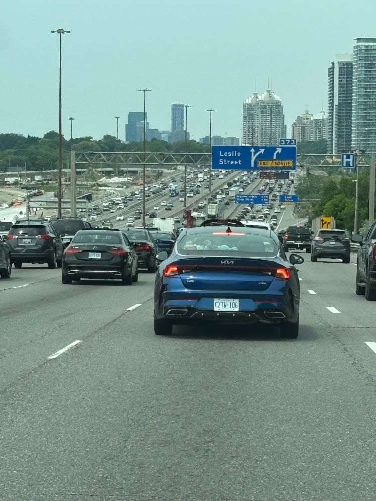 Cars. Lots of cars on a many lane highway. 