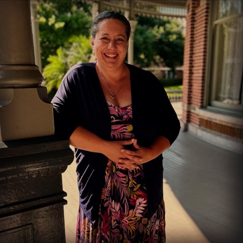 Image of Sarah Smith-Frigerio standing on the veranda of plant hall at the University Tampa. 
