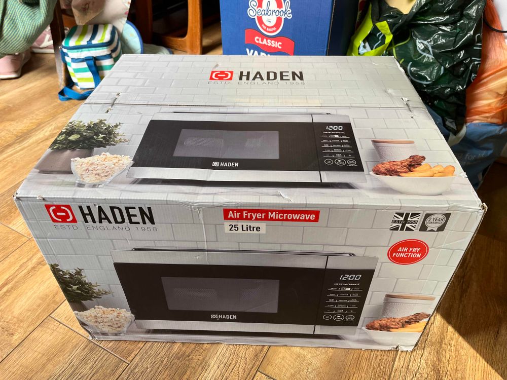 A big cardboard box containing a combination microwave and air fryer 