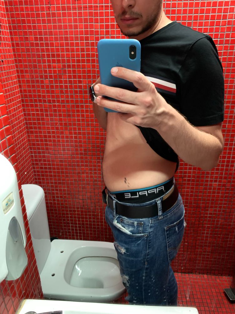 Greek man in a random bathroom after visiting the gay clubs. 