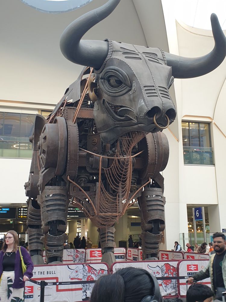 Supersized metal mechanical bull behind 1m barrier 