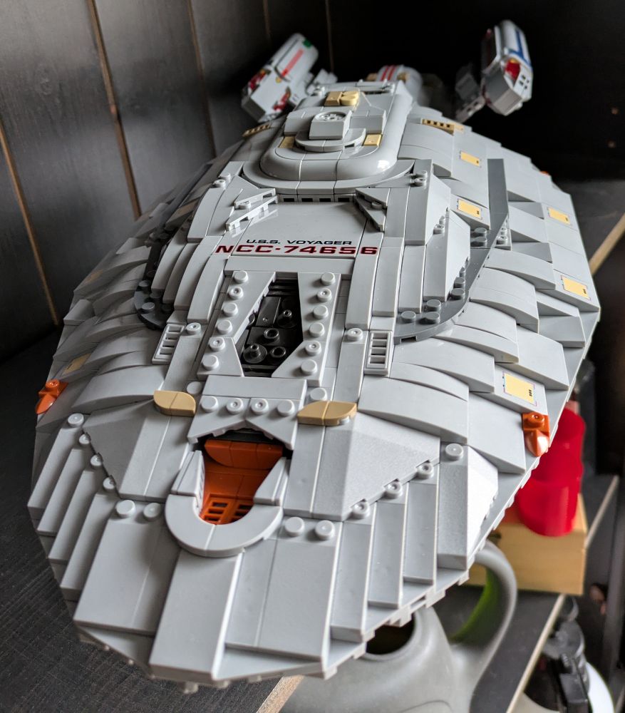 a model of the USS Voyager from the Star Trek franchise made from Lego like bricks, front view showing details 