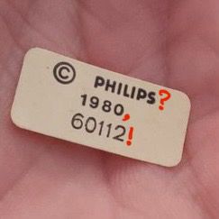 The OP’s mystery sticker, now marked up unhelpfully with additional punctuation in reference to that lawyer’s business-card joke on The Simpsons.