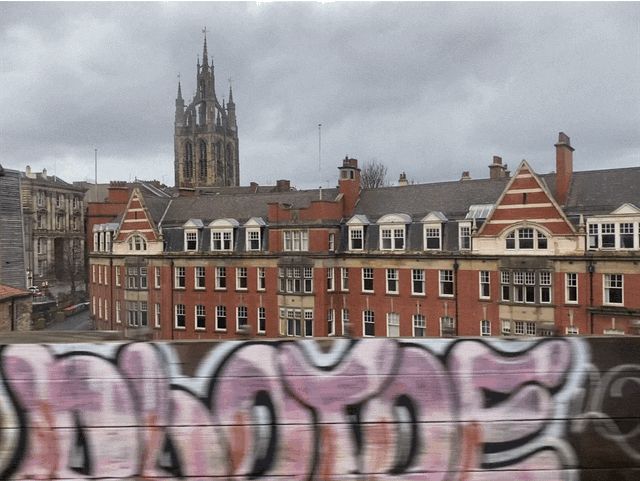 Some graffiti as we approach Newcastle railway station. Sky is eight eighths occluded.