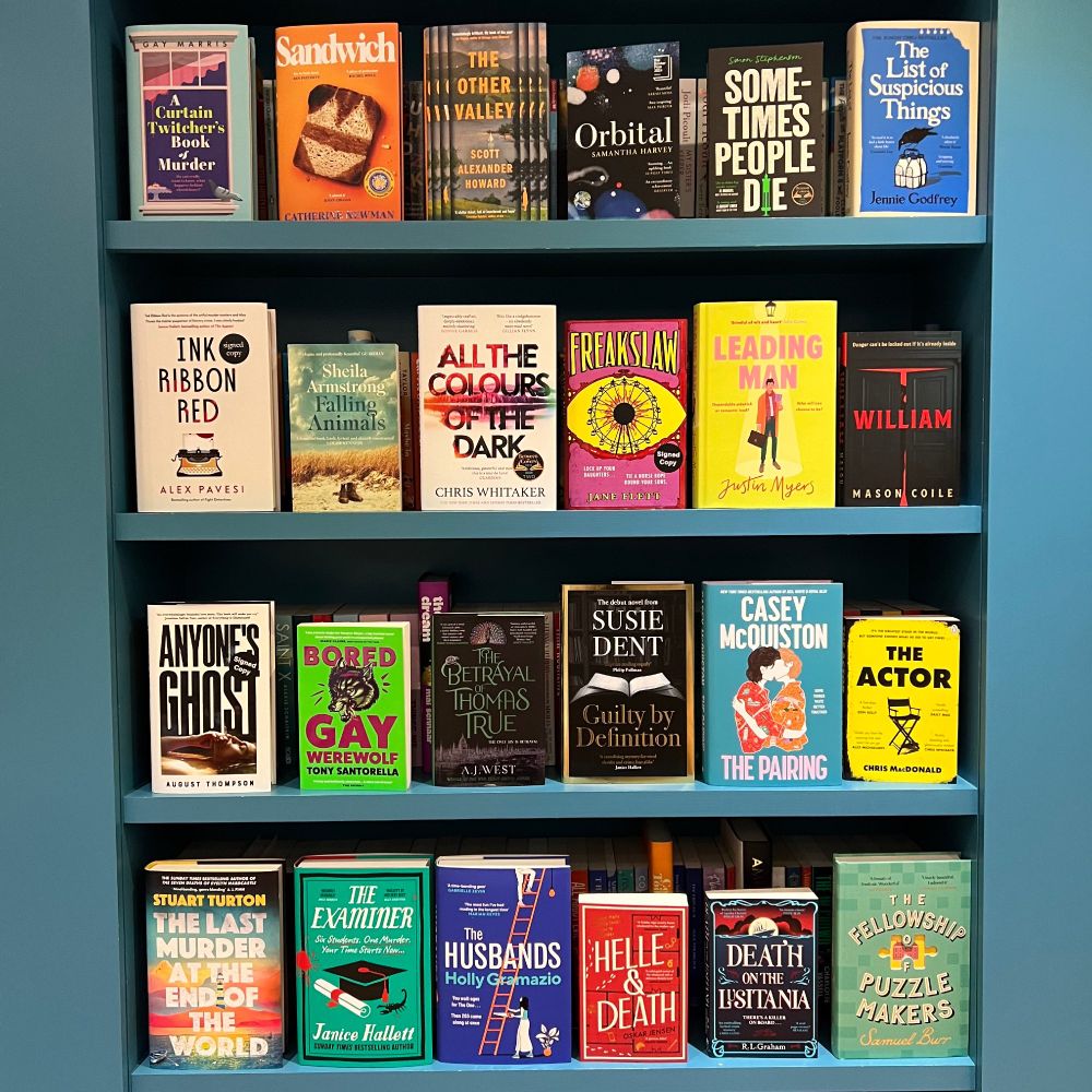 4 shelves of books:
Shelf 1: A Curtain Twitcher's Book of Murder; Sandwich; The Other Valley; Orbital; Sometimes People Die; The List of Suspicious Things
Shelf 2: Ink Ribbon Red; Falling Animals; All the Colours of the Dark; Freakslaw; Leading Man; William
Shelf 3: Anyone's Ghost; Bored Gay Werewolf; The Betrayal of Thomas True; Guilty By Definition; The Pairing; The Actor
Shelf 4: The Last Murder at the End of the World; The Examiner; The Husbands; Helle & Death; Death on the Lusitania; The Fellowship of the Puzzlemakers