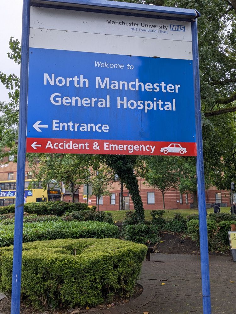 The North Manchester General Hospital sign, soaked by rain....