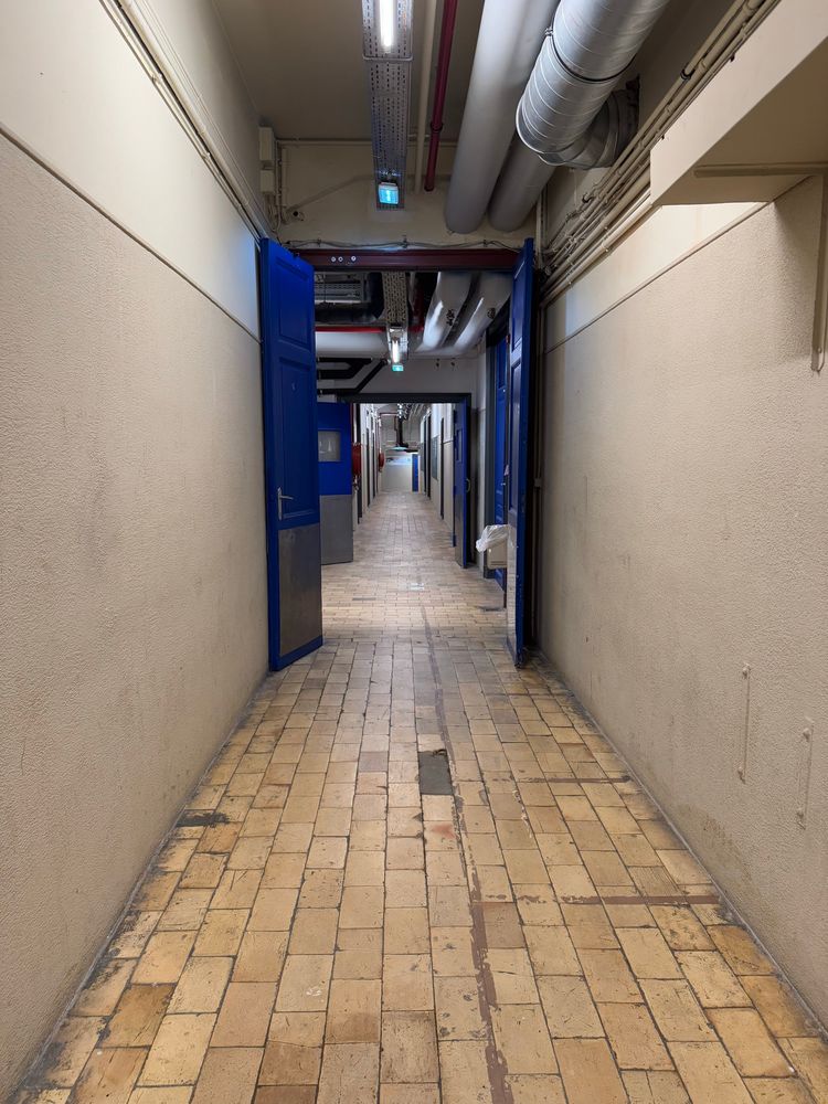 A long corridor with lots of doors