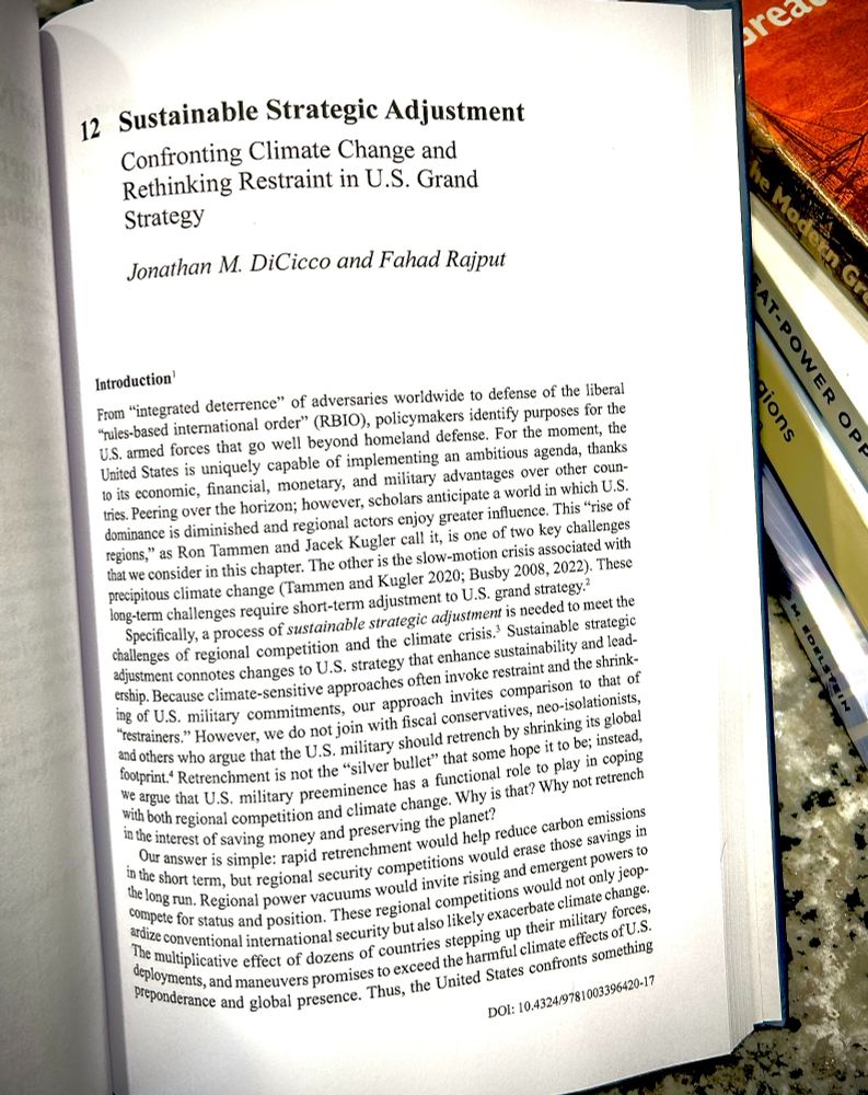 A photograph of the first page of the chapter titled "Sustainable Strategic Adjustment: Confronting Climate Change and Rethinking Restraint in U.S. Grand Strategy," by Jonathan M. DiCicco and Fahad Rajput (Chapter 12 in the book The Sources of Great Power Competition).