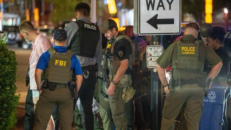 A man who worked for the Department of Justice was charged after allegedly throwing a sandwich at a federal law enforcement officer in Washington, DC, amid President Donald Trump’s takeover of the cit...