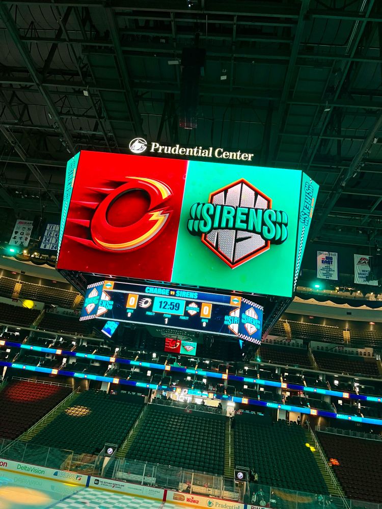 the scoreboard at the prudential center showing the Ottawa charge and New York sirens logos