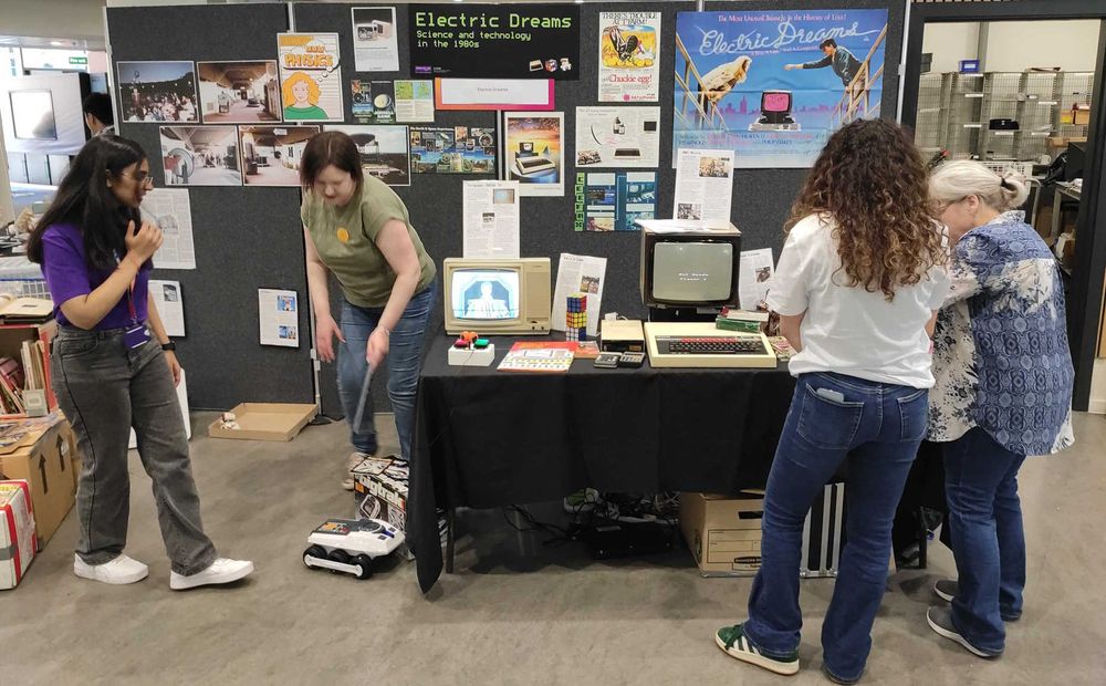 Photo of stall with vintage computer equipment and posters.