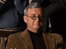 Meme of an older man in brown sport coat raising glass of whiskey while other men clap
