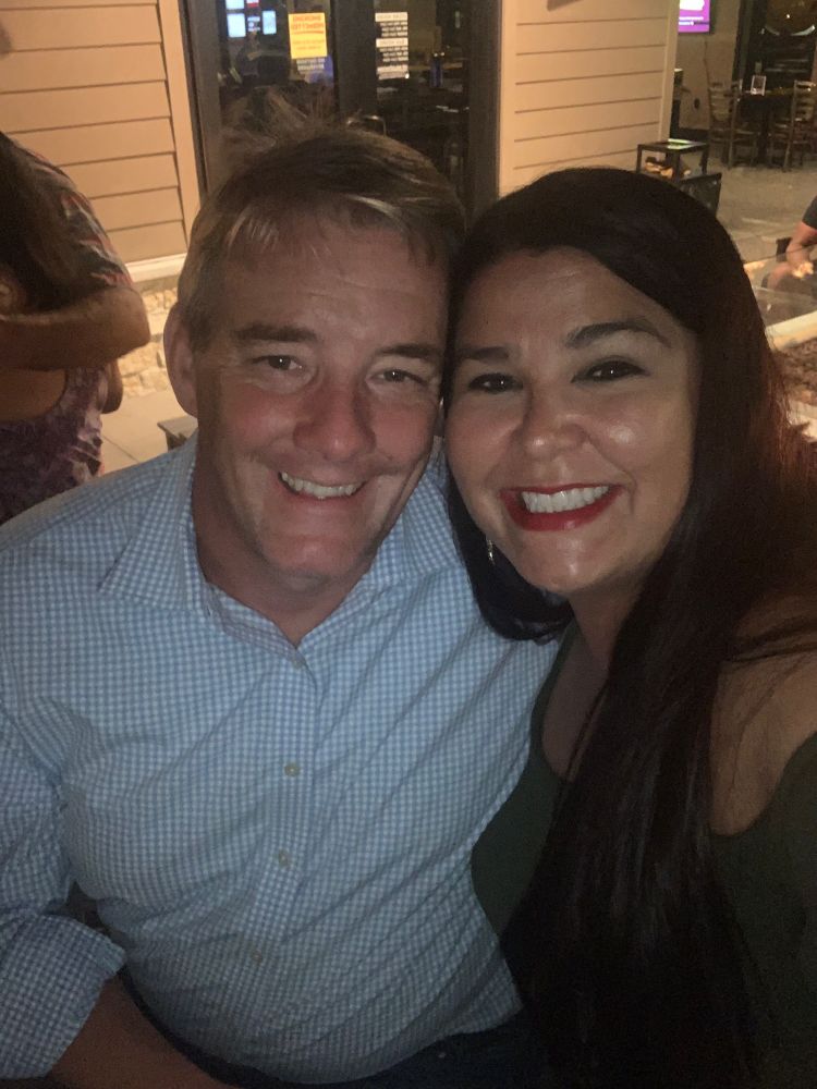 Julie and her husband smiling. 