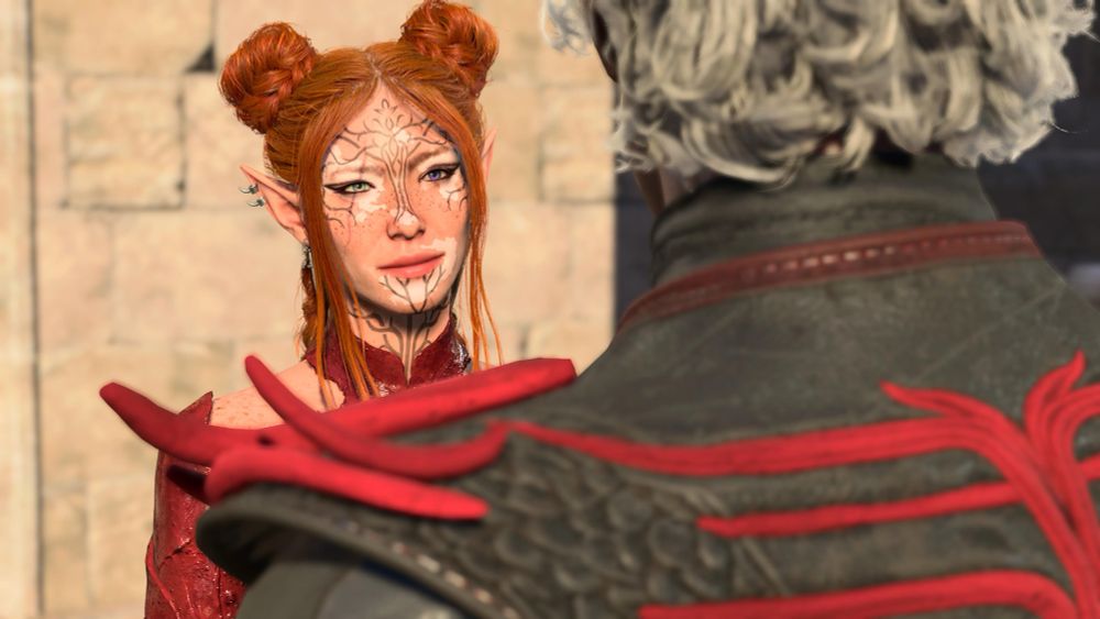 A picture of a baldurs gate 3 tav character taken from over someone else’s shoulder. The character is an elf and has red hair, different color eyes, and face tattoos. 