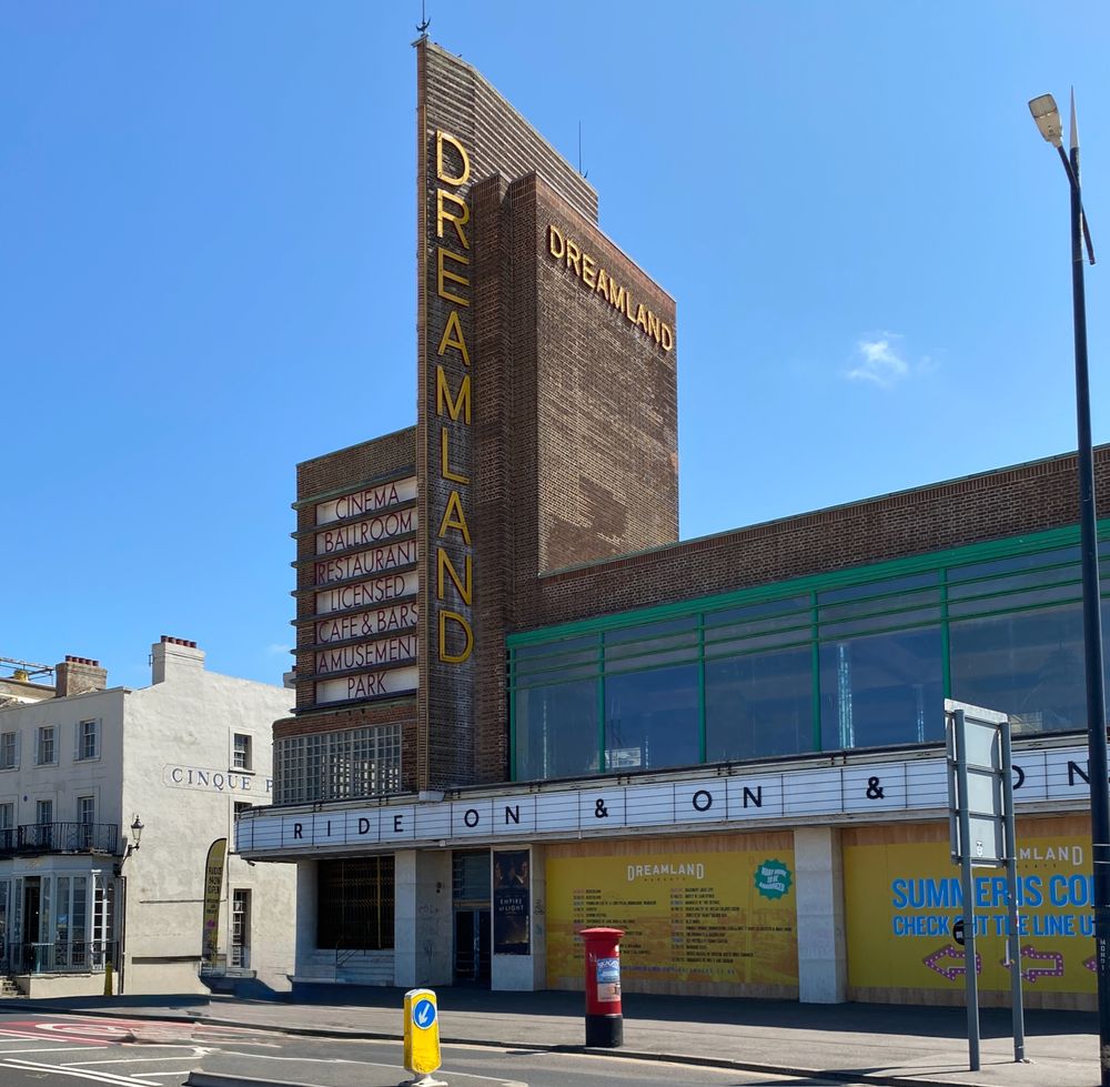 The Dreamland cinema Margate, Art-Deco in Dutch-style rich brown brick, with tall fin-shaped tower, shorter tower to left with illuminated sign board. 