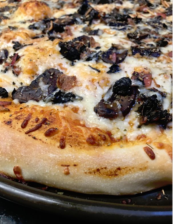 The baked pizza, close up, showing the thick crust because I stretched the dough and let it rise for a couple hours. Looks OK. 