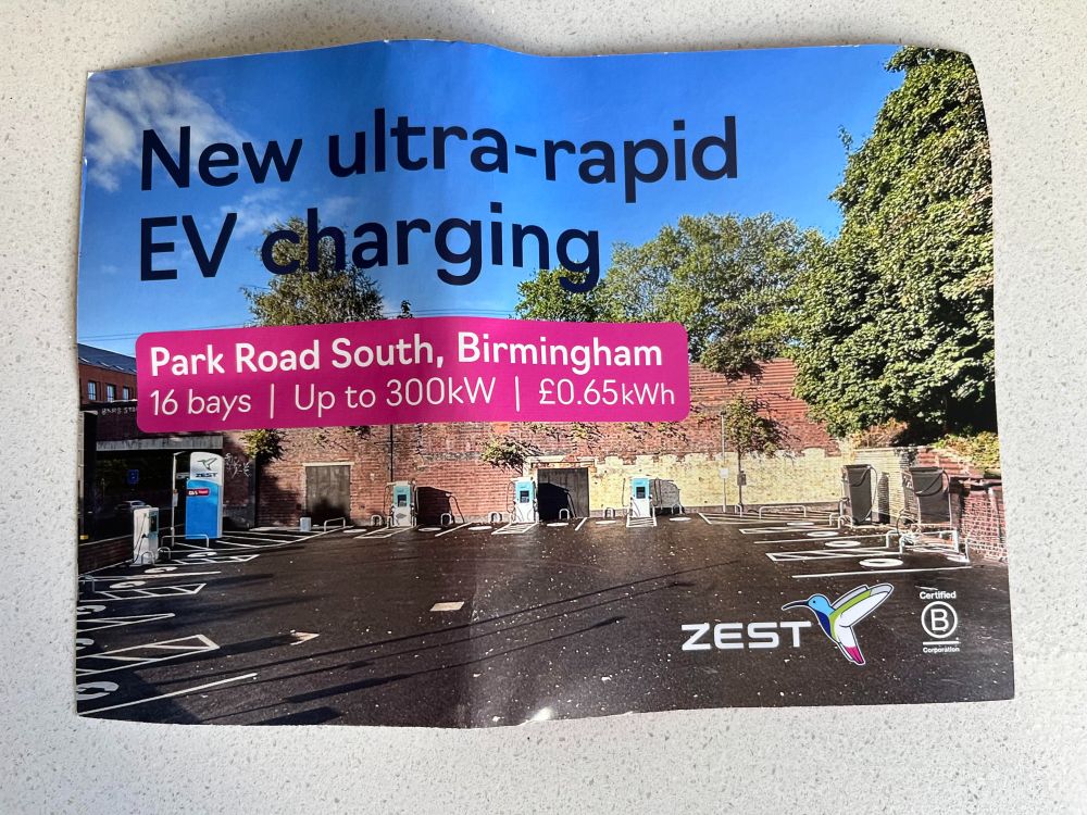 An ad for electric car charging featuring yet another paved car park in Birmingham.