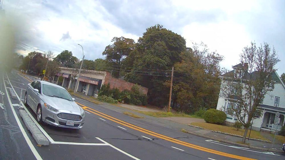 same street with two lanes and a shared-use bike/walking path