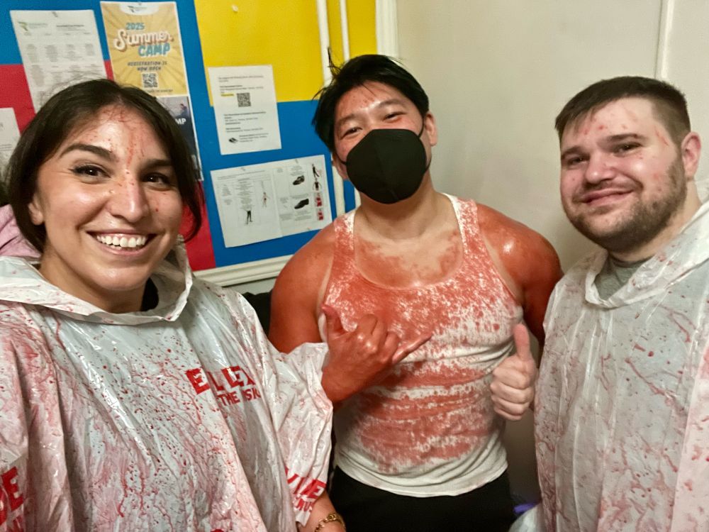 Steve and his two friends. He’s DRENCHED in fake blood and his shirt is super stained. Two friends are next to him in plastic ponchos lol. 