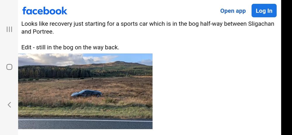 Black sports car in a bog on the Sligeachan to Portree road.