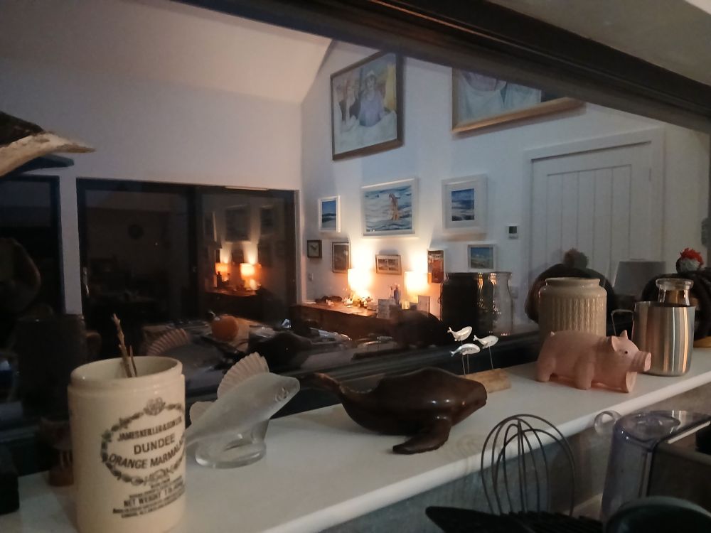 Kitchen window at night, bits and bobs on window ledge
