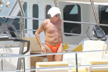 Rod Stewart in a skimpy bathing suit and with a towel on his head. If you're blind or low vision, be glad you can't see this. 