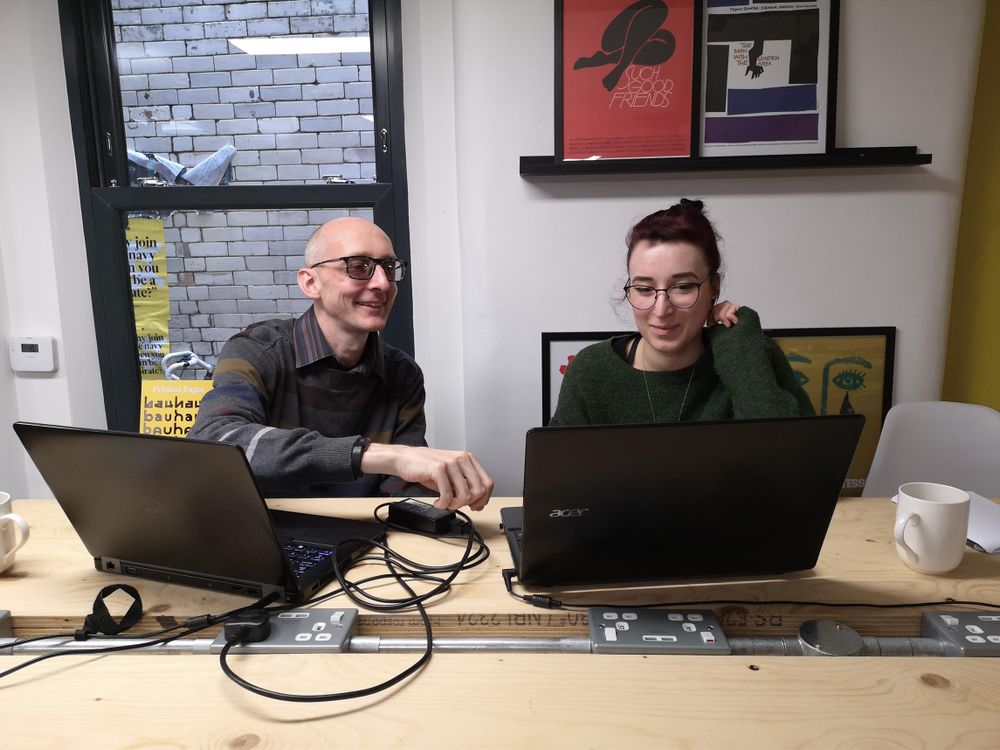 Two Pixelshrink staff members looking at computer screens