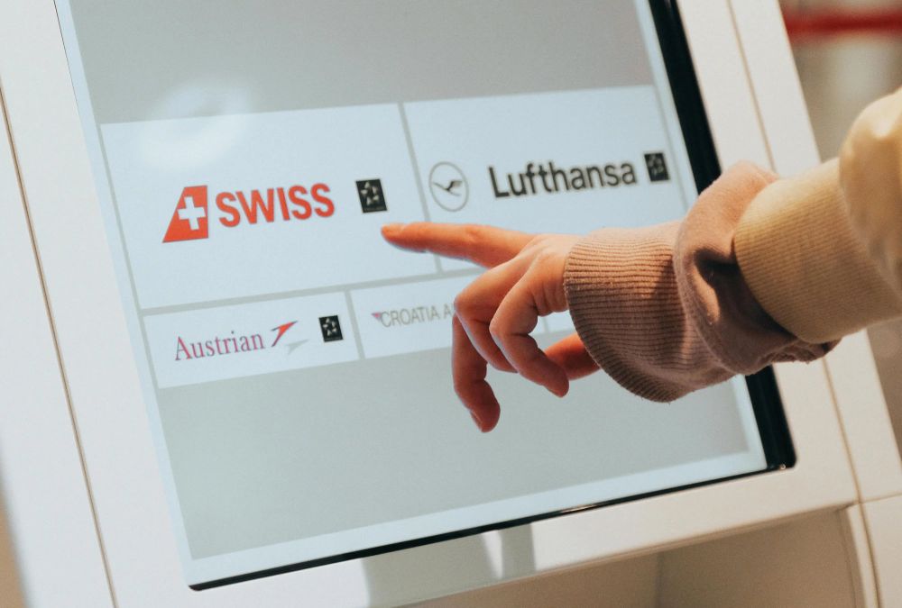 Web design for kiosks - photo of someone using a touchscreen kiosk
