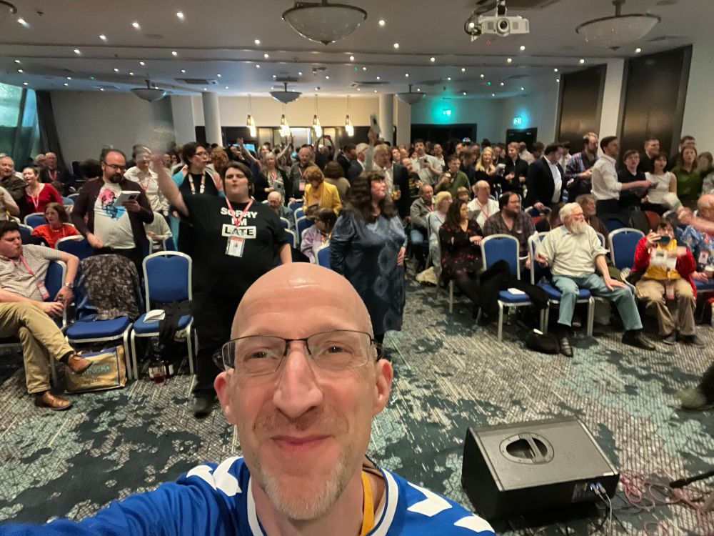 Richard Clein co-compere of Liberal Democrat Glee Club in Harrogate March 2025