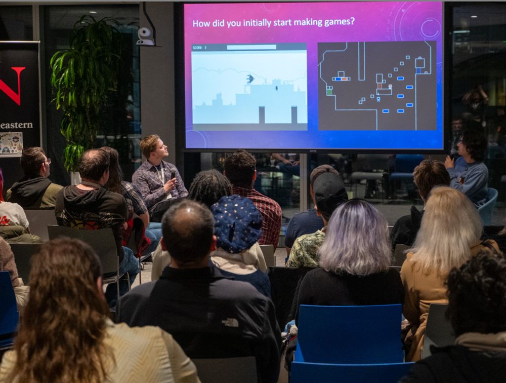 Noel Berry and Ali Estaki speaking in front of the audience at Vancouver Game Dev Series in December 2024