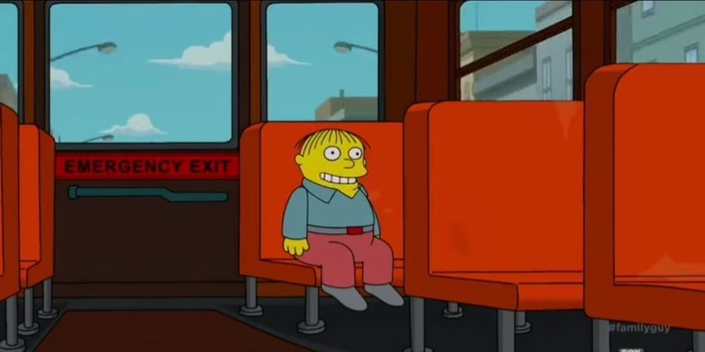 Ralph Wiggam sitting on a school bus, smiling.
