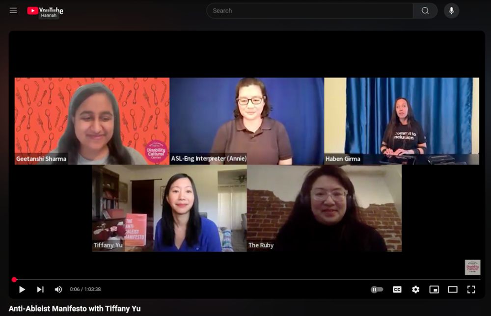  A screenshot of the DCC’s youtube video titled, “Anti-Ableist Manifesto with Tiffany Yu” captures DCC fellow Geetanshi Sharma, ASL-Eng interpreter Annie, director of The Ruby Peggy Lee, moderator Haben Girma, and speaker Tiffany Yu all smiling. DCC logo at the bottom right. Geetanshi, a young Indian American woman wears grey in front of an orange customized DCC background. Annie has short black hair, glasses, wears a black polo, and is in front of a deep blue background. Peggy has black hair, glasses, black shirt, headphones, and is in front of a brick wall. Haben, a Black woman in her thirties with mid length black hair wears a shirt that reads, “Commit to Inclusion.” She is in front of satin blue curtains and is using a braille device. Tiffany, an East Asian woman with mid length black hair, wears a bright blue top and sits in a house with her book “The Anti-Ableist Manifesto.” The Youtube logo and search bar is at the top and the DCC logo is at the bottom.
