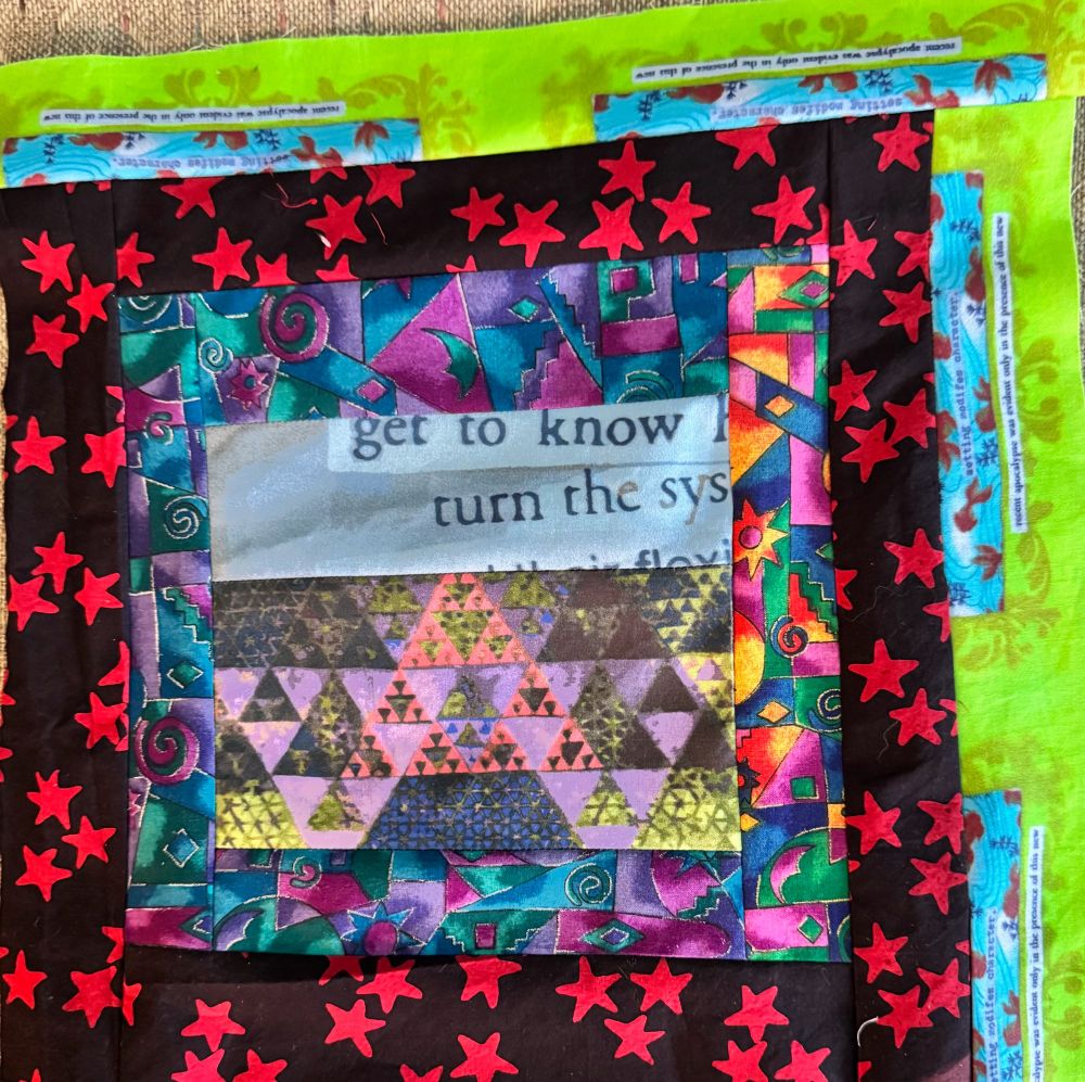 A brightly colored quilt block with triangles & stars.