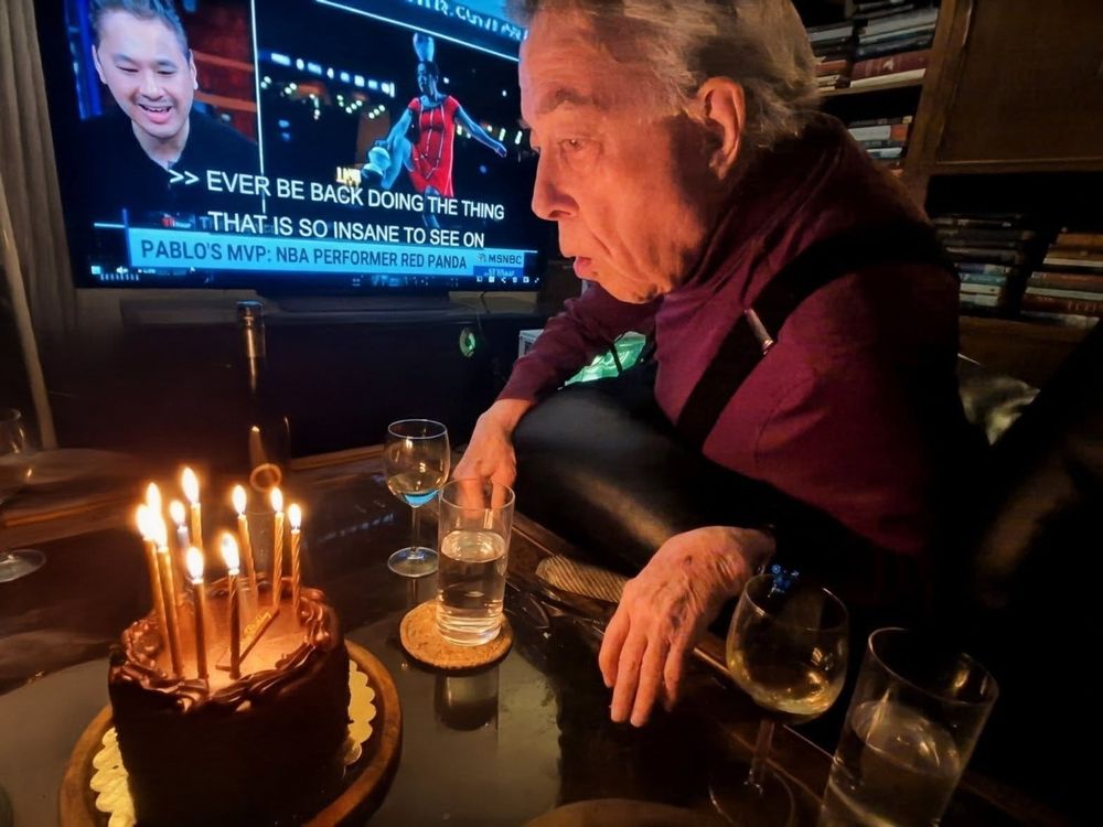 John Cramer blowing out birthday candles.