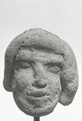 Male head, possibly representing a foreigner.  Headdress probably intended to be of Egyptian type. Head made as a separate piece, free-modeled.