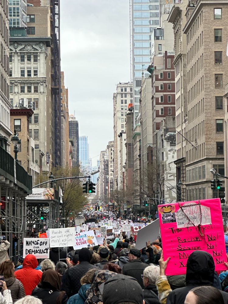 5th Avenue in Manhattan full of people holding signs.
