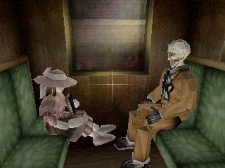 A little girl in pink and an older man sit across from each other in a train