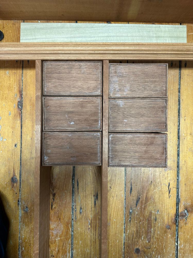 The drawers laid out with the molding and strips of wood in a 2x3 arrangement 