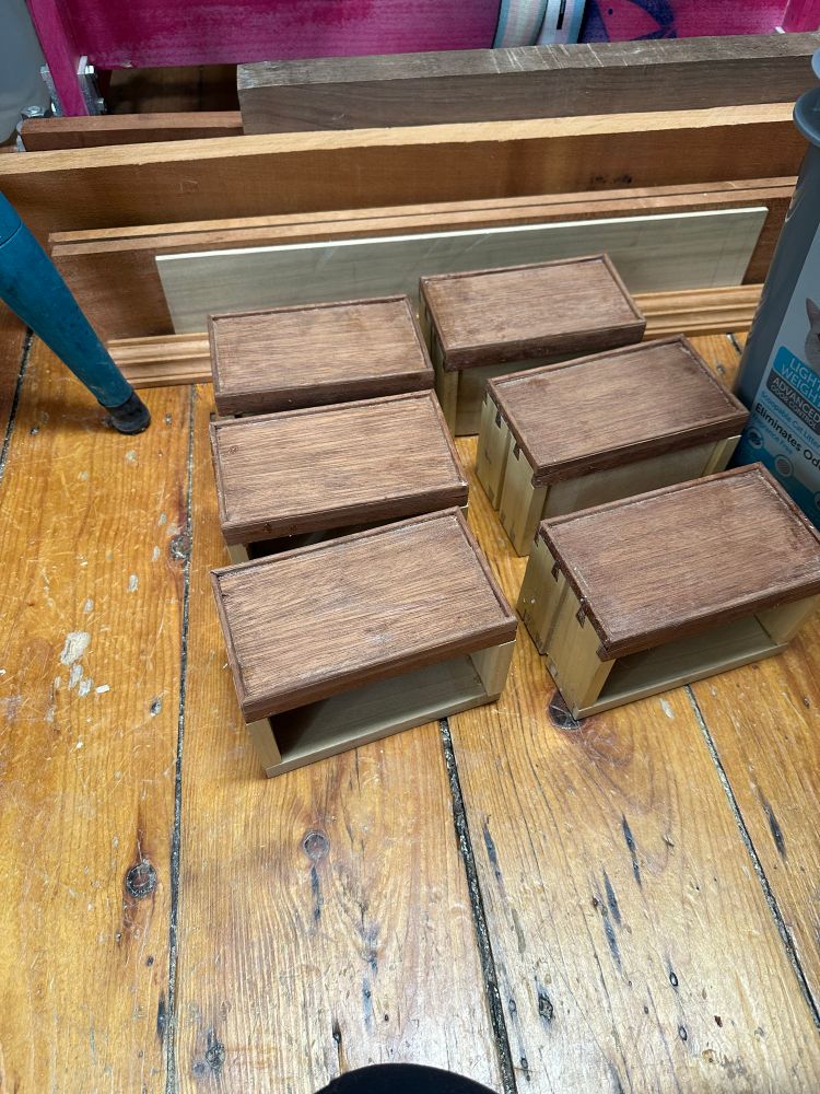 Six dovetailed tiny drawers boxes with applied cockbeading, made of mahogany fronts and poplar backs and sides, sitting on the floor glue drying 