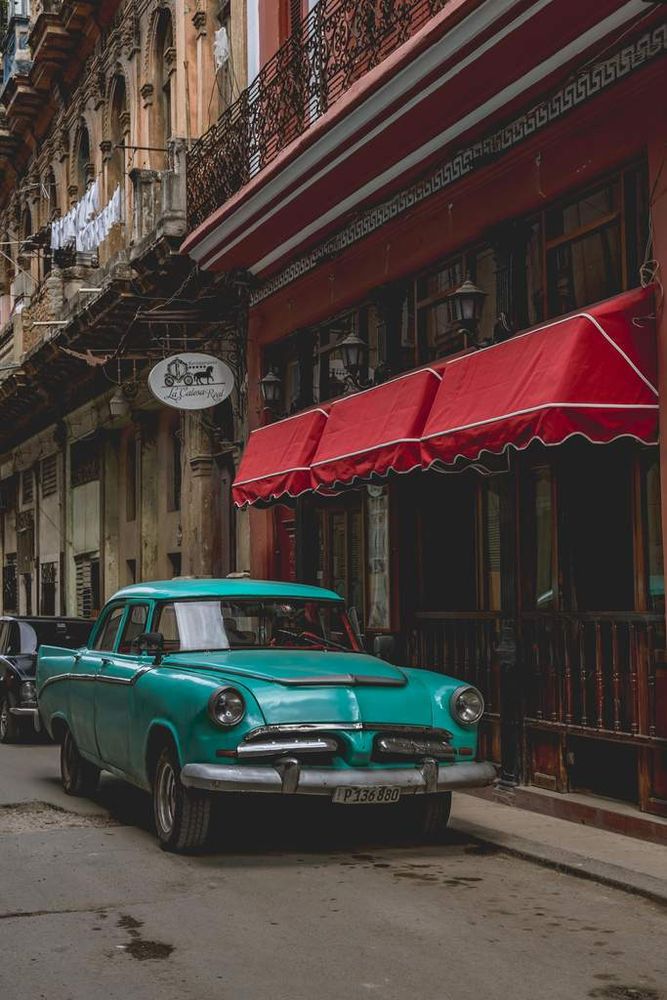 Classic vintage car parked in front of an old building, highlighting urban nostalgia and historical architecture.